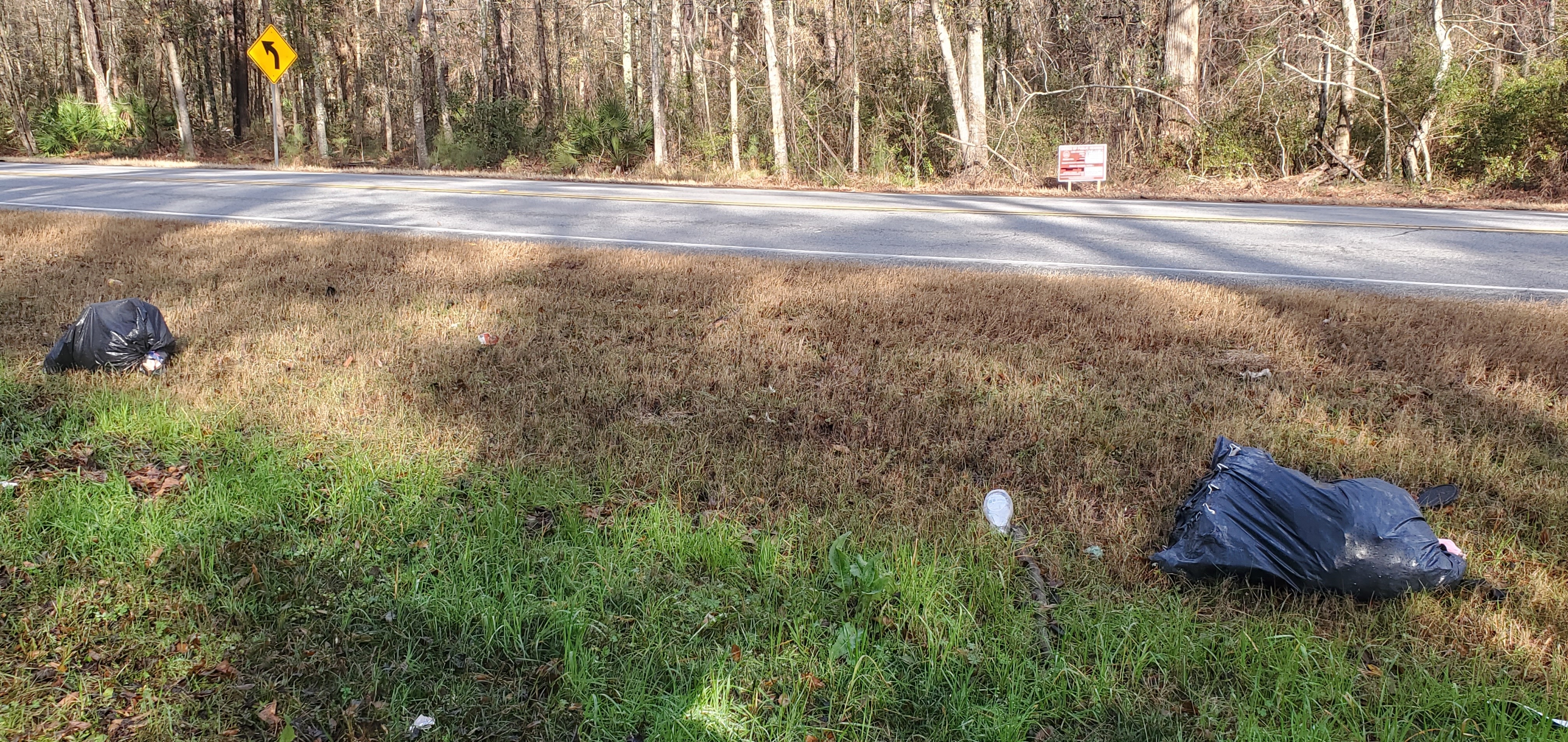 Trash bags across GA 122 from the rezoning notice sign